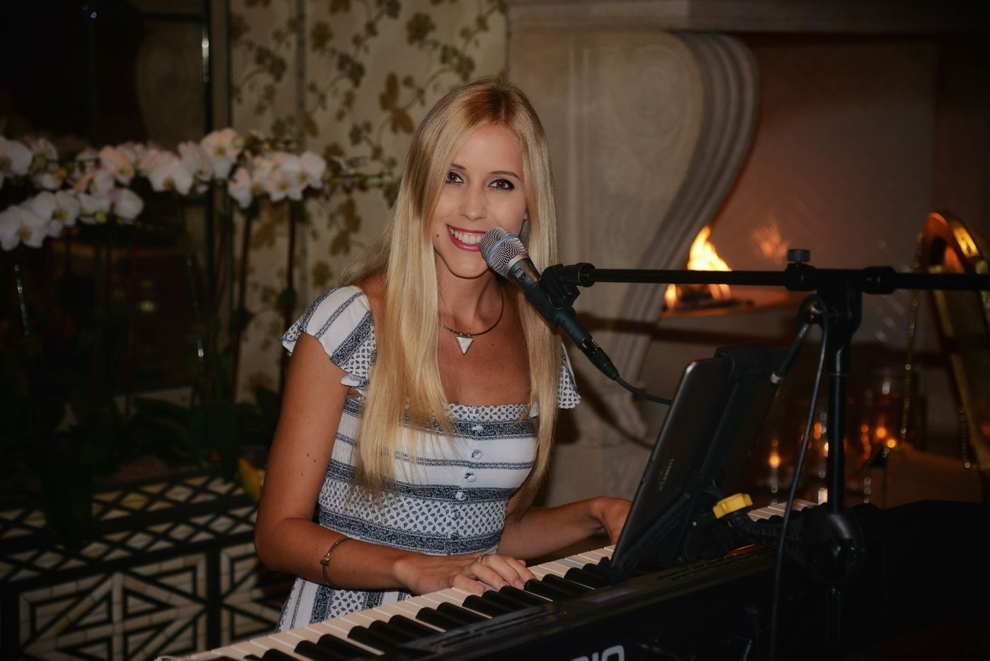 Joanna performing by a fireplace